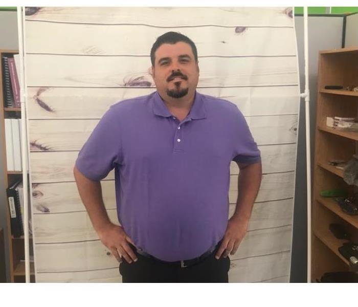 male employee with goatee in purple shirt 